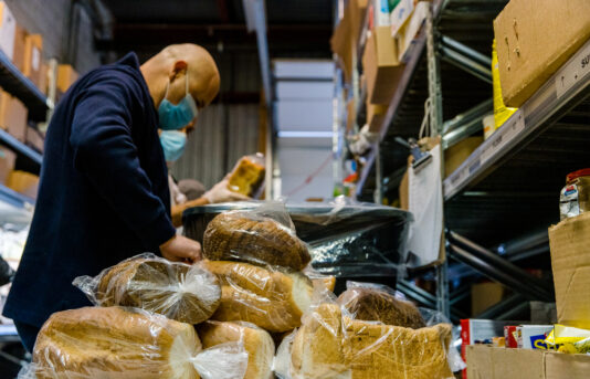 Man Working in Food Pantry (Bread)
